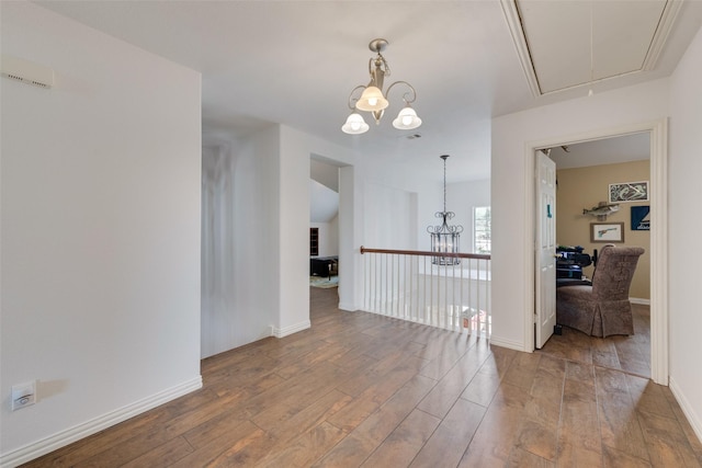 113 Bob White Ct, Rockwall, TX 75087 - spare room with attic access, baseboards, wood finished floors, and a chandelier