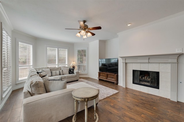 113 Bob White Ct, Rockwall, TX 75087 - living area with ornamental molding, a tile fireplace, a ceiling fan, and dark wood-style flooring