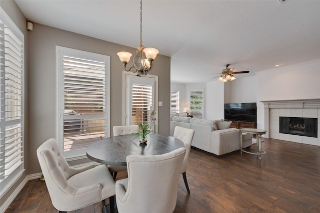 113 Bob White Ct, Rockwall, TX 75087 - dining area featuring ceiling fan with notable chandelier, dark wood-style floors, and a fireplace