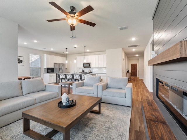 542 Freed Dr, Fate, TX 75087 - living room with a fireplace, a ceiling fan, wood finished floors, and recessed lighting