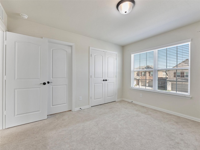 542 Freed Dr, Fate, TX 75087 - unfurnished bedroom featuring light colored carpet, baseboards, and two closets