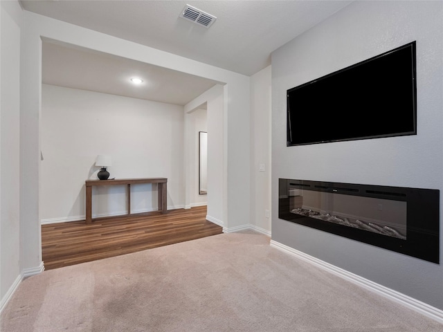 542 Freed Dr, Fate, TX 75087 - carpeted spare room featuring baseboards, a glass covered fireplace, and recessed lighting