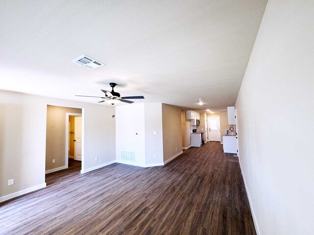 2385 Miller St, Denison, TX 75020 - kitchen featuring a sink, black range with electric cooktop, stainless steel microwave, dark wood-type flooring, and visible vents