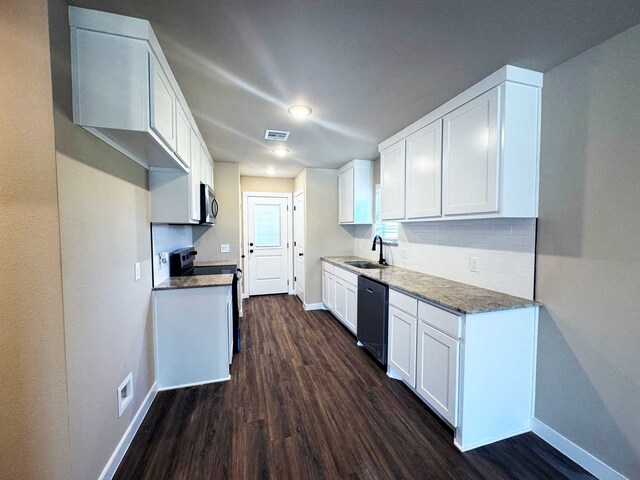 2385 Miller St, Denison, TX 75020 - kitchen featuring white cabinets, stainless steel dishwasher, a sink, dark wood-type flooring, and decorative backsplash