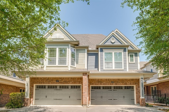 4523 W University Blvd, Dallas, TX 75209 - view of front of home featuring an attached garage, driveway, a shingled roof, and brick siding