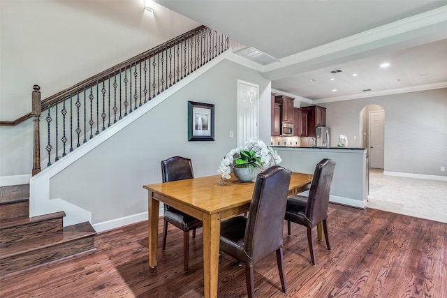 4523 W University Blvd, Dallas, TX 75209 - dining space with ornamental molding, arched walkways, wood finished floors, stairs, and recessed lighting