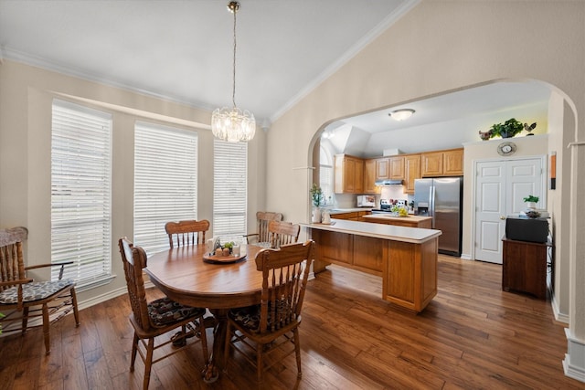 dining space with high vaulted ceiling, crown molding, hardwood / wood-style flooring, arched walkways, and an inviting chandelier