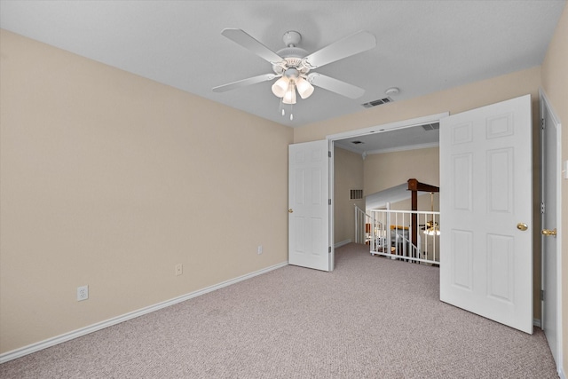 unfurnished bedroom with ceiling fan, visible vents, baseboards, and light carpet