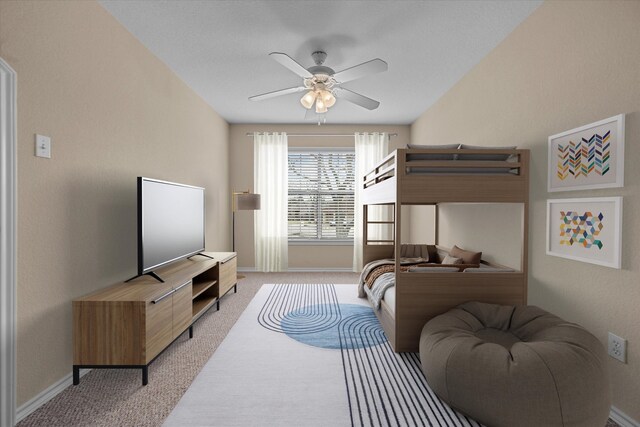 bedroom with light colored carpet, ceiling fan, and baseboards