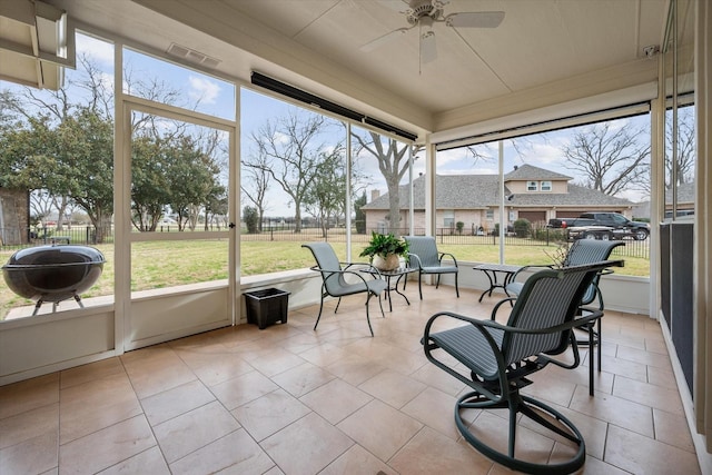 sunroom featuring ceiling fan
