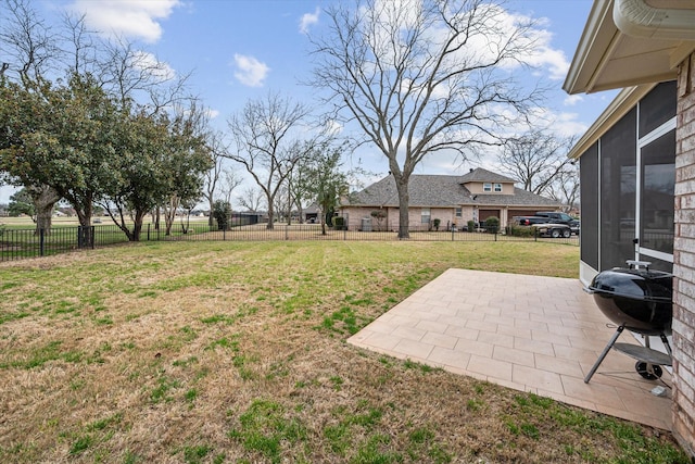 view of yard featuring a sunroom, a patio, and fence