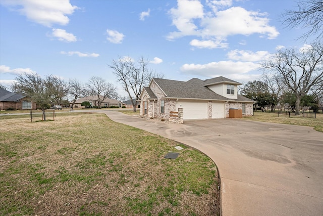 view of side of property featuring stone siding, a lawn, and concrete driveway