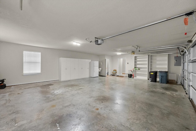 garage featuring freestanding refrigerator, electric panel, and a garage door opener
