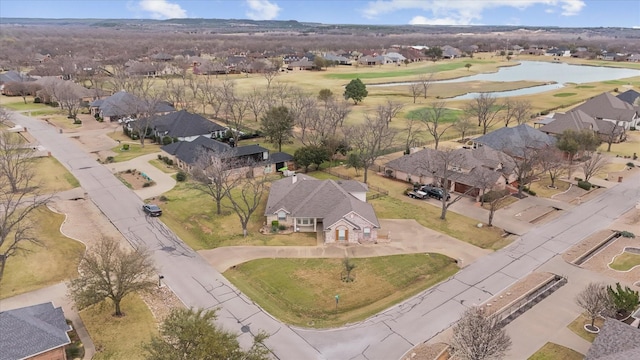 drone / aerial view featuring a residential view and a water view