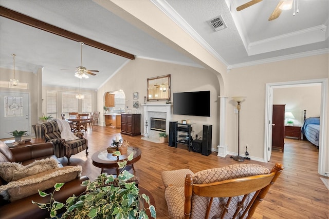 living room with a premium fireplace, light wood-style floors, and ceiling fan