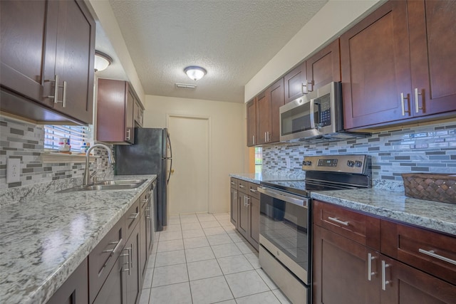 1234 Royal Oak Dr, Desoto, TX 75115 - kitchen with decorative backsplash, appliances with stainless steel finishes, a sink, and visible vents