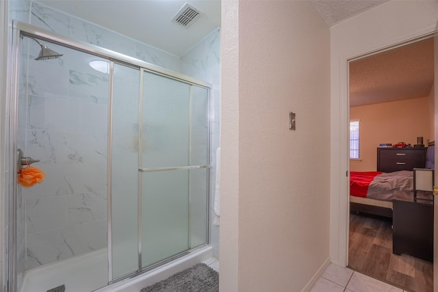 1234 Royal Oak Dr, Desoto, TX 75115 - ensuite bathroom featuring connected bathroom, a textured ceiling, visible vents, and a stall shower