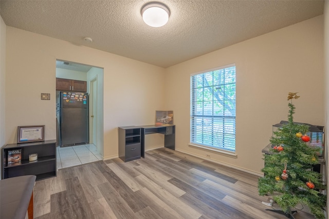 1234 Royal Oak Dr, Desoto, TX 75115 - unfurnished office featuring light wood-style floors, a textured ceiling, and baseboards