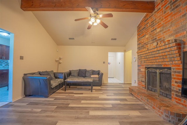 1234 Royal Oak Dr, Desoto, TX 75115 - living room with a ceiling fan, wood finished floors, vaulted ceiling with beams, a fireplace, and visible vents