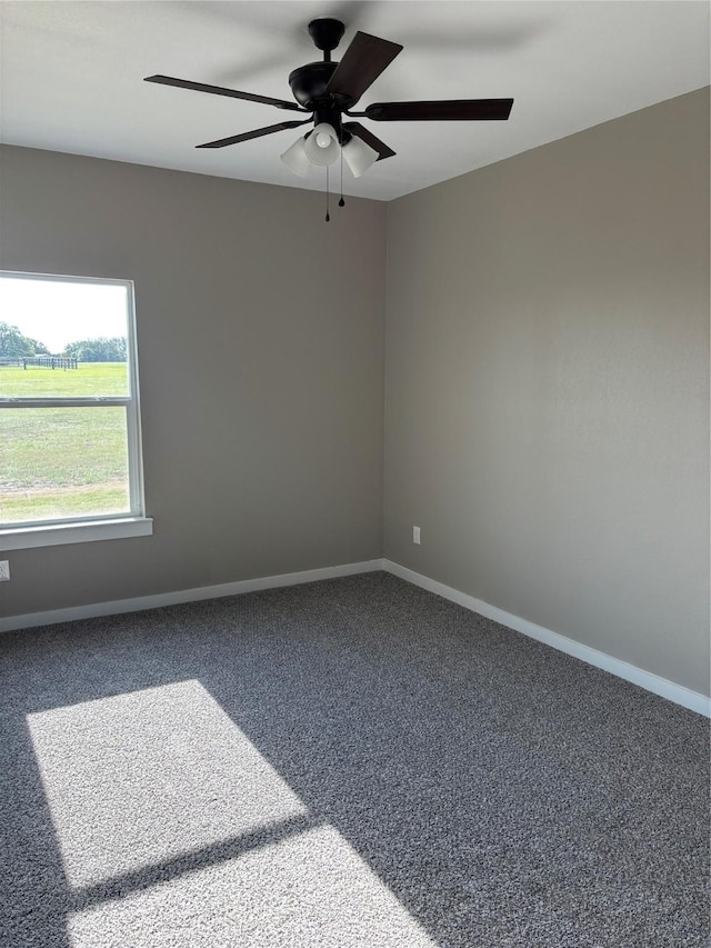 spare room with carpet flooring, a ceiling fan, and baseboards
