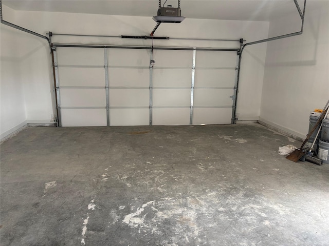 garage featuring baseboards and a garage door opener