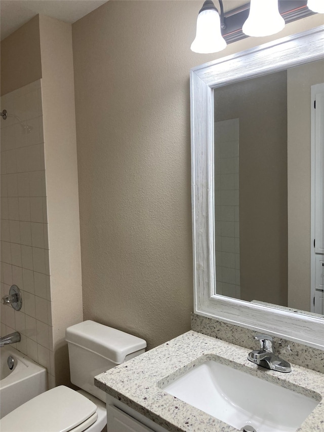 3833 Dana Ct, Abilene, TX 79606 - full bath with vanity, a textured wall, bathtub / shower combination, and toilet