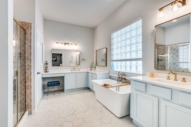 full bath featuring two vanities, a shower stall, a soaking tub, and a sink