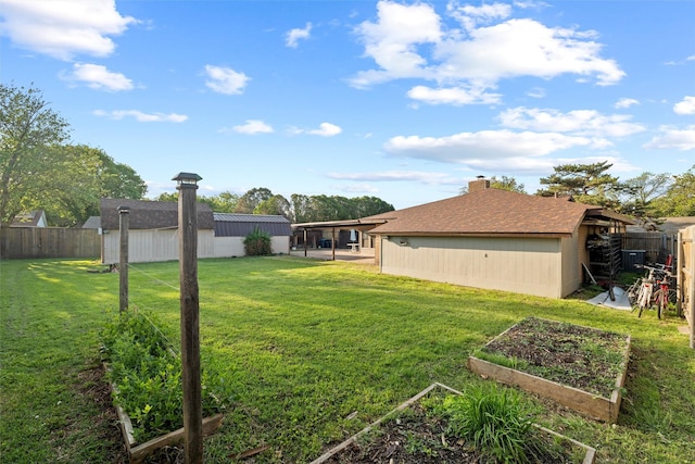 view of yard with a fenced backyard and a vegetable garden