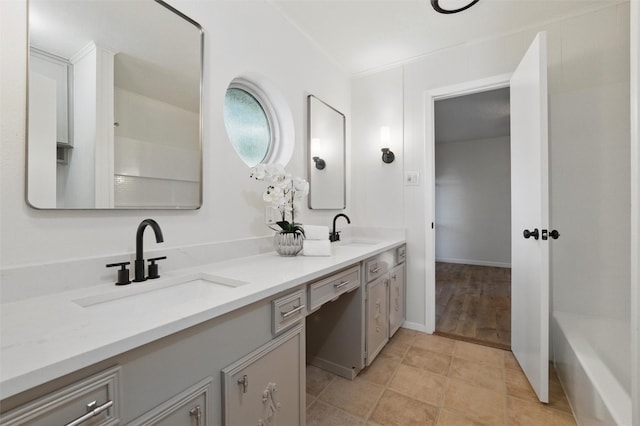 bathroom with a sink and double vanity