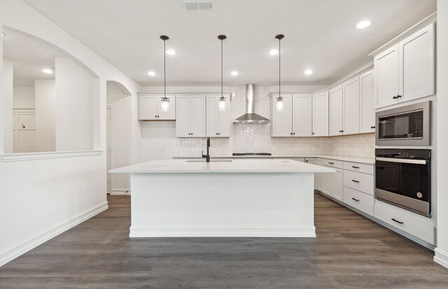 1624 Cottonwood Valley Dr, Celina, TX 75009 - kitchen featuring oven, wall chimney exhaust hood, a sink, built in microwave, and a center island with sink