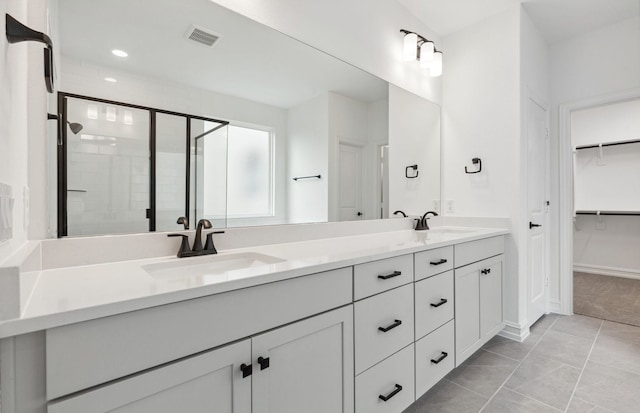 1624 Cottonwood Valley Dr, Celina, TX 75009 - bathroom with a shower stall, double vanity, a spacious closet, and baseboards