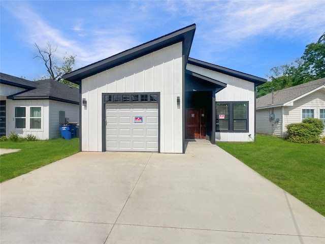 view of front of property featuring a front lawn, driveway, and board and batten siding