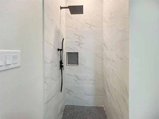 full bathroom with a marble finish shower