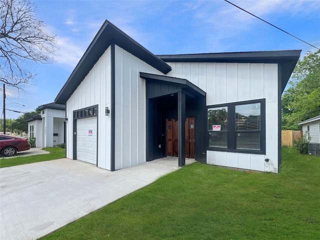exterior space with board and batten siding, a lawn, driveway, and an attached garage