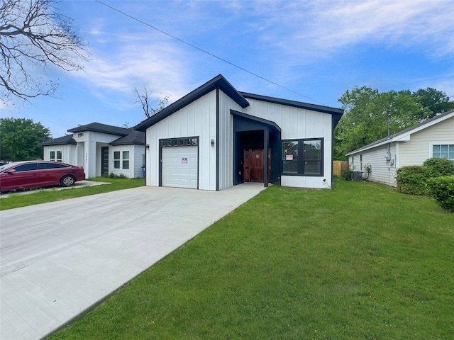 exterior space with board and batten siding, an attached garage, a lawn, and concrete driveway