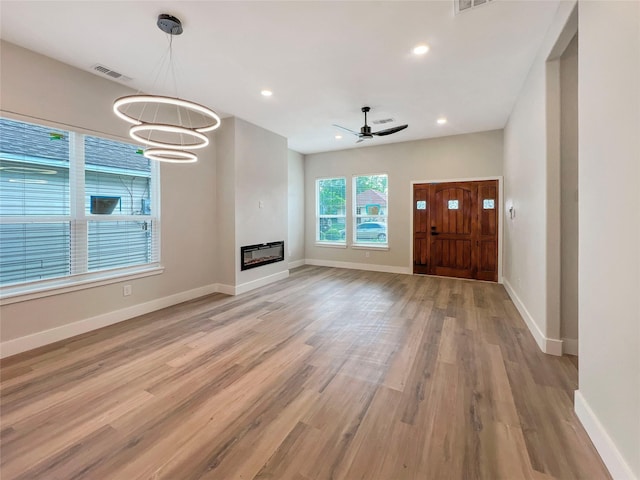 unfurnished living room featuring recessed lighting, baseboards, visible vents, and light wood-style flooring