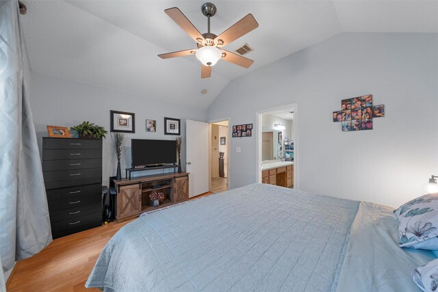 bedroom with ceiling fan, lofted ceiling, visible vents, and light wood-style flooring