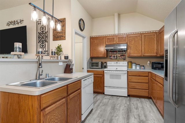 kitchen with lofted ceiling, light wood finished floors, under cabinet range hood, a sink, and white appliances