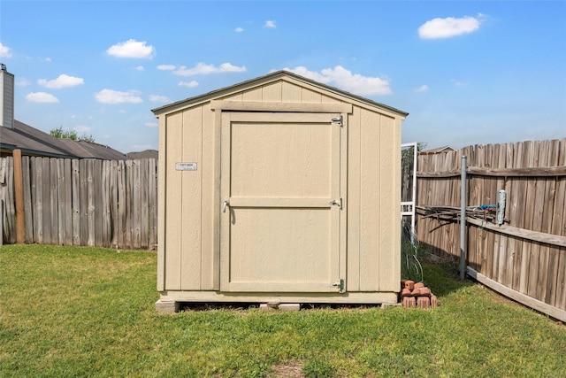 view of shed with a fenced backyard