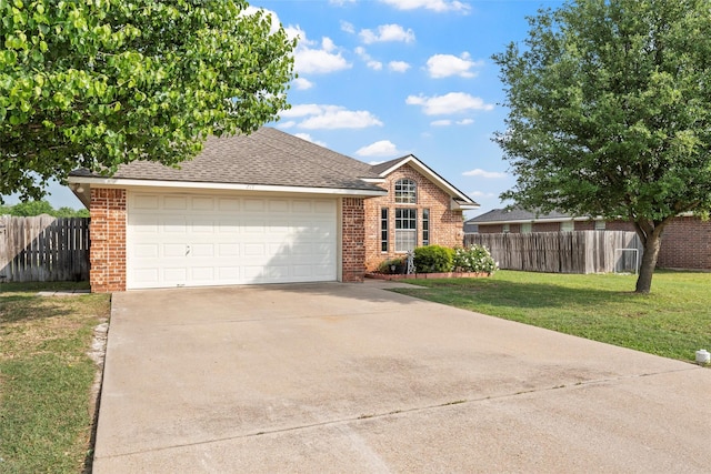 ranch-style house featuring an attached garage, brick siding, driveway, and a front yard