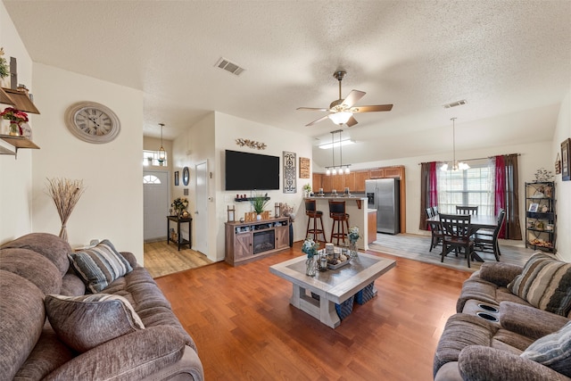 living room with visible vents, ceiling fan, and a healthy amount of sunlight