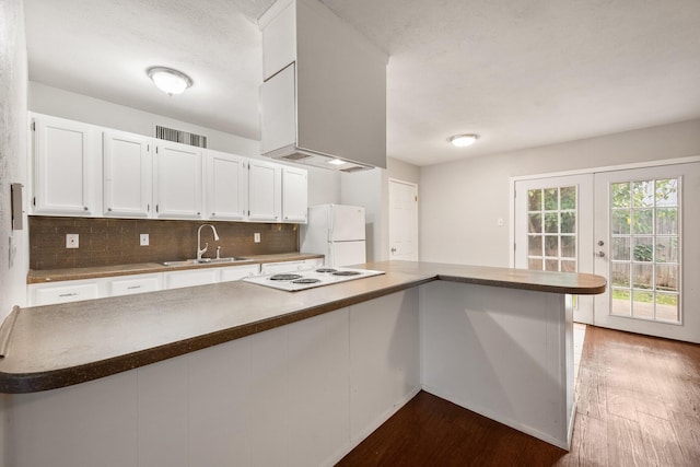 6606 Greenfield Dr, Arlington, TX 76016 - kitchen with tasteful backsplash, a sink, white appliances, dark wood finished floors, and white cabinetry