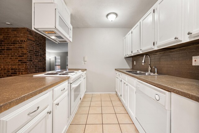 6606 Greenfield Dr, Arlington, TX 76016 - kitchen featuring dark countertops, white appliances, a sink, and tasteful backsplash