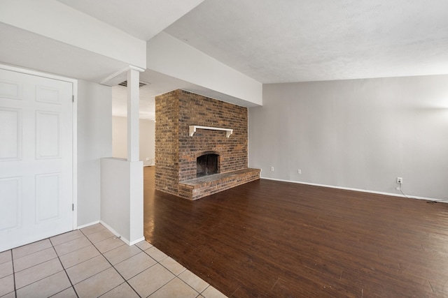 6606 Greenfield Dr, Arlington, TX 76016 - unfurnished living room featuring baseboards, a brick fireplace, tile patterned floors, and visible vents
