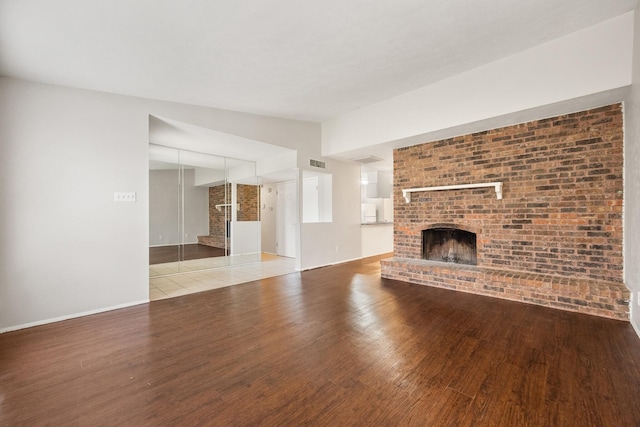 6606 Greenfield Dr, Arlington, TX 76016 - unfurnished living room featuring a fireplace, wood finished floors, visible vents, and baseboards