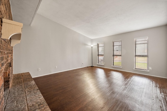 6606 Greenfield Dr, Arlington, TX 76016 - unfurnished living room with baseboards and dark wood-type flooring