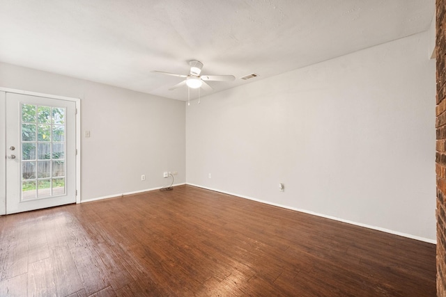 6606 Greenfield Dr, Arlington, TX 76016 - spare room featuring baseboards, a ceiling fan, visible vents, and dark wood-type flooring