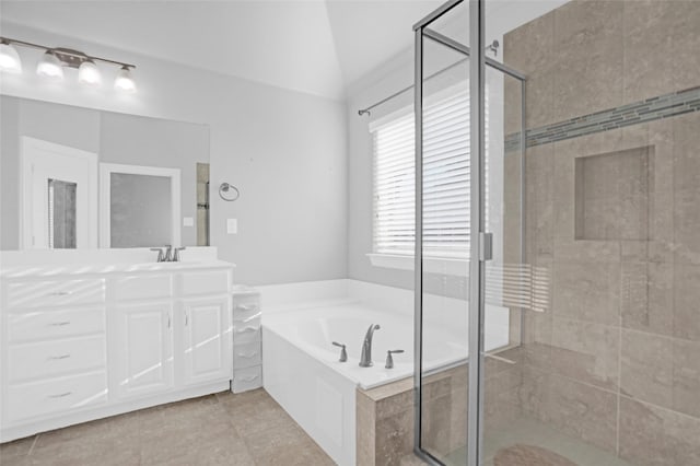 bathroom featuring a garden tub, tile patterned flooring, a shower stall, vaulted ceiling, and vanity