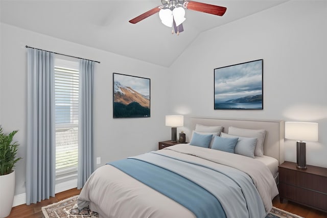 bedroom with vaulted ceiling, wood finished floors, and ceiling fan