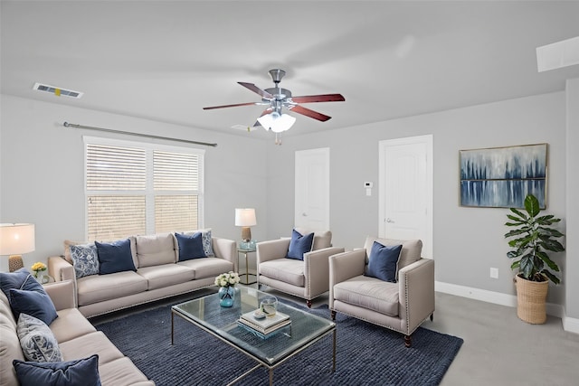 living room featuring a ceiling fan, baseboards, visible vents, and carpet